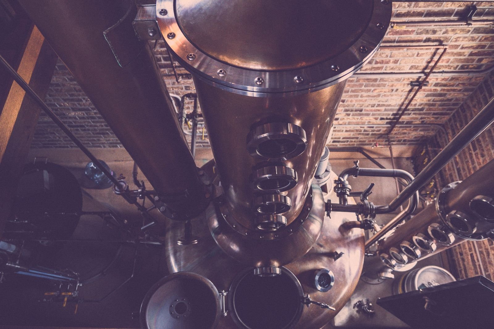 A copper pot still inside a working distillery